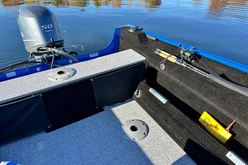 Slide: The Image of Manufacturer Provided Image: Interior of a 2026 Smoker Craft Lazer 161 boat with fishing rod and motor. - 8
