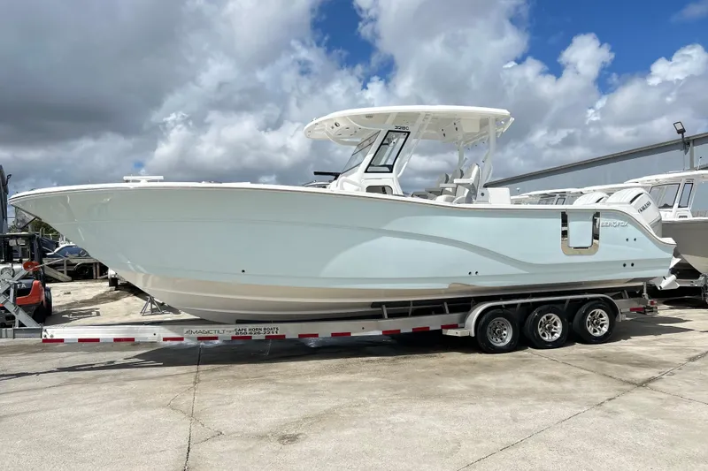 The Image of 2026 Sea Fox 328 Commander boat on trailer under cloudy sky. - 0