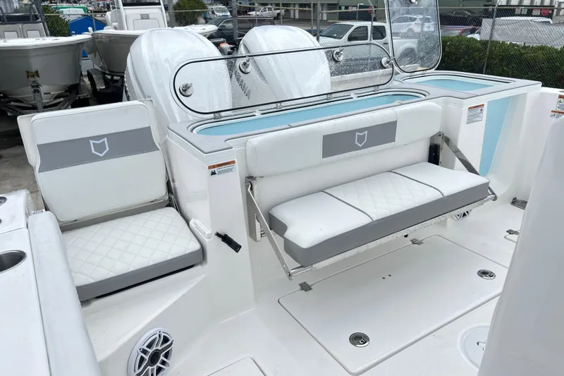 Slide: The Image of 2026 Sea Fox 328 Commander boat interior with white seating and storage compartments. - 14