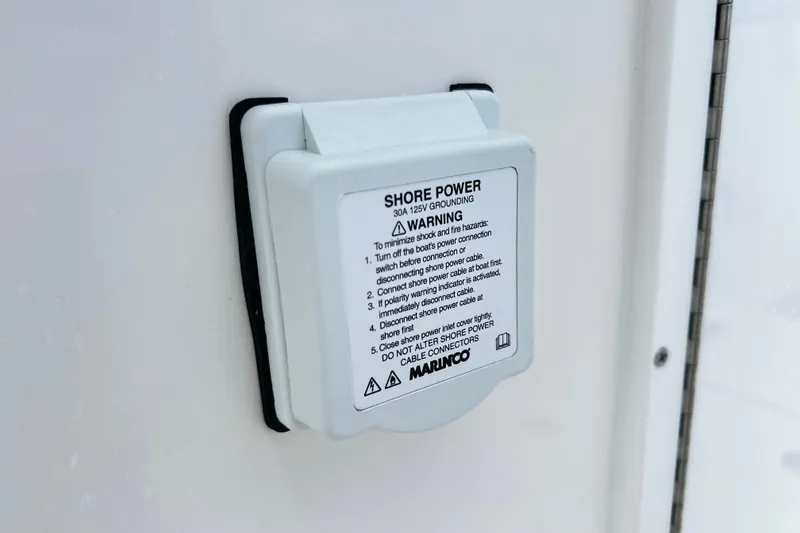 Slide: The Image of Shore power outlet on 2026 Sea Fox 328 Commander boat with safety instructions. - 19