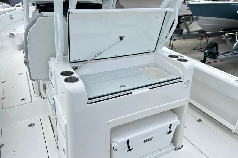 Slide: The Image of 2026 Sea Fox 328 Commander boat interior with open storage and cooler. - 22