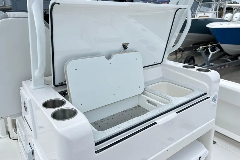 Slide: The Image of 2026 Sea Fox 328 Commander boat with open storage compartment and cup holders. - 23