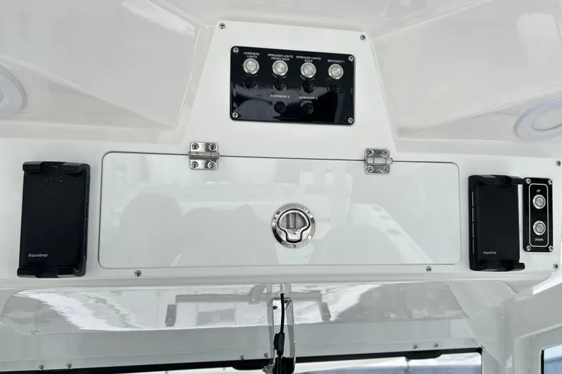 Slide: The Image of Control panel of 2026 Sea Fox 328 Commander boat with switches and storage. - 26