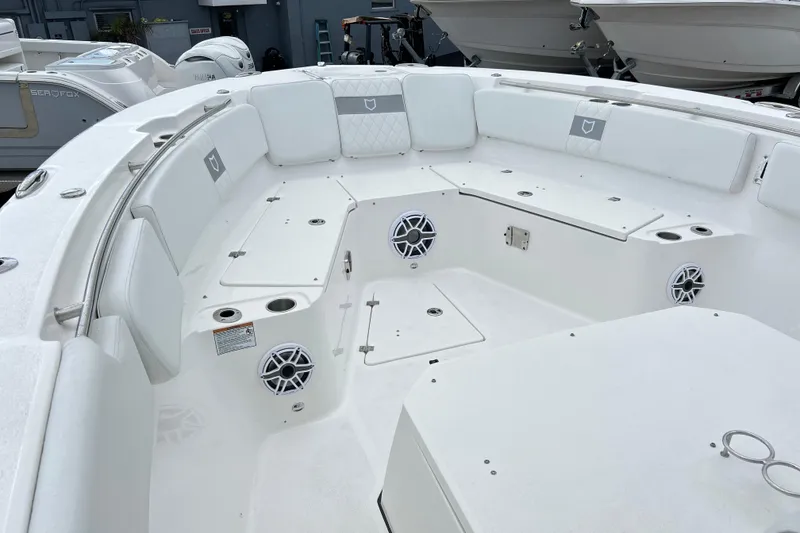 Slide: The Image of 2026 Sea Fox 328 Commander boat interior with white seating and built-in speakers. - 28