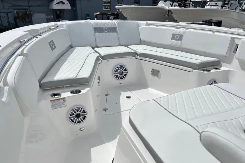 Slide: The Image of Luxurious seating area on 2026 Sea Fox 328 Commander boat, featuring white cushioned seats and speakers. - 33