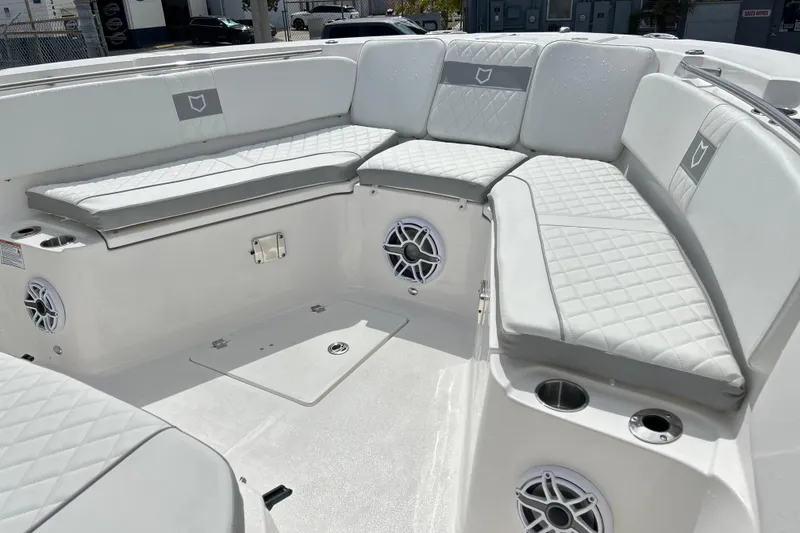 Slide: The Image of 2026 Sea Fox 328 Commander boat interior with cushioned seating and built-in speakers. - 36