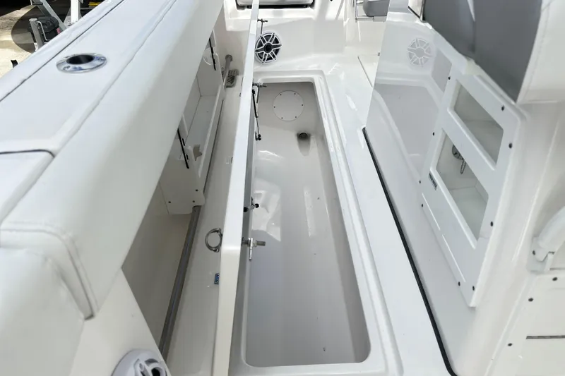 Slide: The Image of 2026 Sea Fox 328 Commander boat interior with open storage compartment and seating. - 38