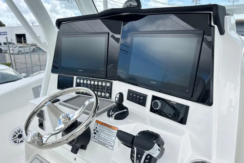 Slide: The Image of 2026 Sea Fox 328 Commander helm with dual Garmin displays and modern controls. - 4
