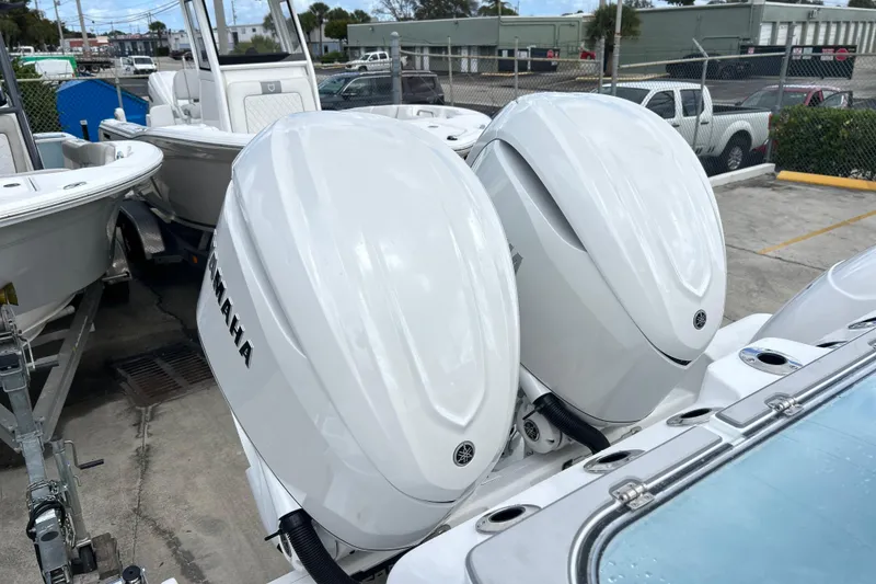Slide: The Image of 2026 Sea Fox 328 Commander with dual Yamaha outboard engines in a marina setting. - 41