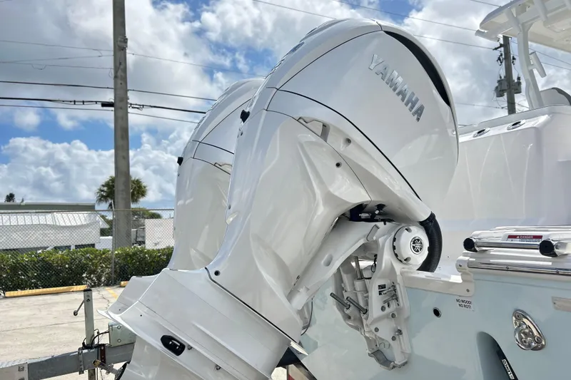 Slide: The Image of 2026 Sea Fox 328 Commander with Yamaha outboard engines, parked outdoors under a cloudy sky. - 43