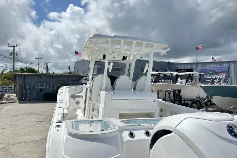 Slide: The Image of 2026 Sea Fox 328 Commander boat displayed outdoors under cloudy sky. - 46