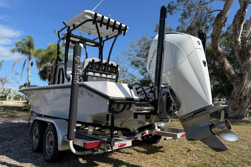 Slide: The Image of 2024 Xplor X24 boat on trailer with powerful outboard motor, parked outdoors. - 10