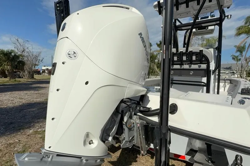 Slide: The Image of 2024 Xplor X24 boat with a powerful Mercury outboard motor, parked outdoors. - 14