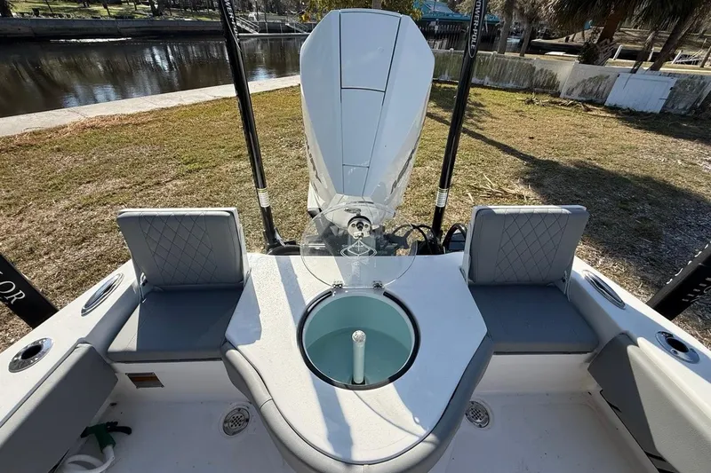Slide: The Image of 2024 Xplor X24 boat interior with seating and motor, near a waterway. - 17