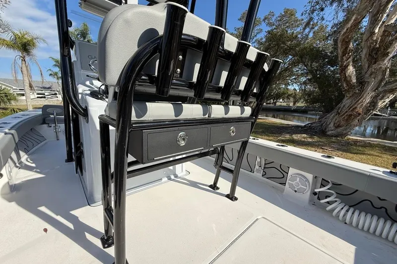 Slide: The Image of 2024 Xplor X24 boat interior with seating and storage, featuring sleek black and white design. - 18