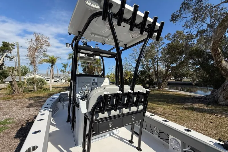 Slide: The Image of 2024 Xplor X24 boat with rod holders and Garmin electronics, parked near a scenic waterway. - 19