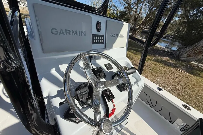 Slide: The Image of 2024 Xplor X24 boat console with Garmin navigation system and steering wheel. - 21