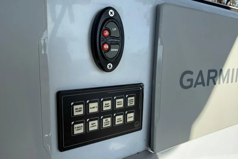 Slide: The Image of Control panel on 2024 Xplor X24 boat with Garmin system and various switches. - 23