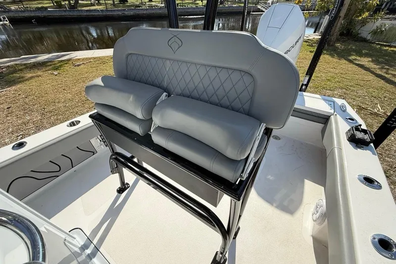 Slide: The Image of 2024 Xplor X24 boat with gray cushioned seating and sleek design. - 24