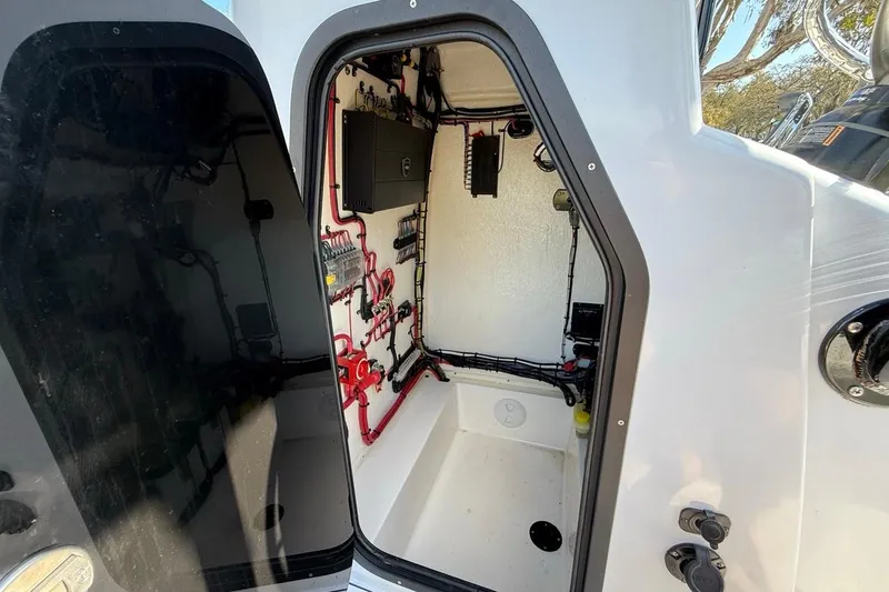 Slide: The Image of Interior view of 2024 Xplor X24 boat's electrical compartment with wiring and components. - 26