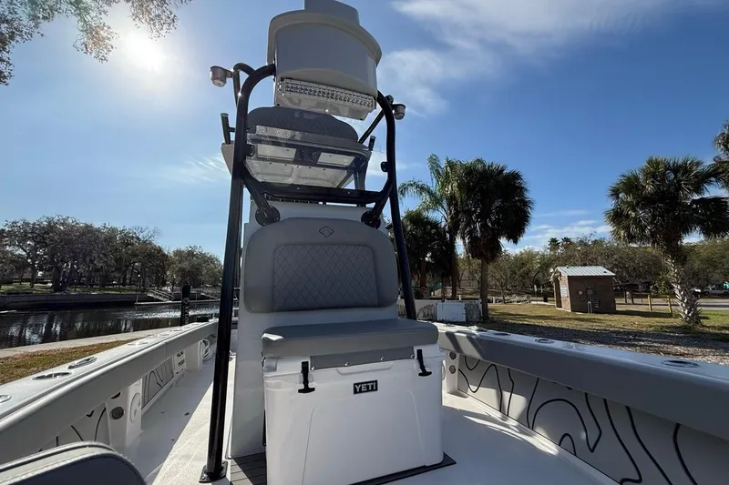 Slide: The Image of 2024 Xplor X24 boat with elevated seating, palm trees in background. - 31