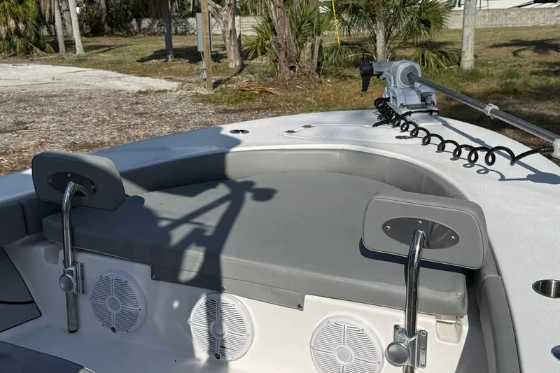 Slide: The Image of 2024 Xplor X24 boat interior with seating, speakers, and trolling motor in a natural setting. - 35