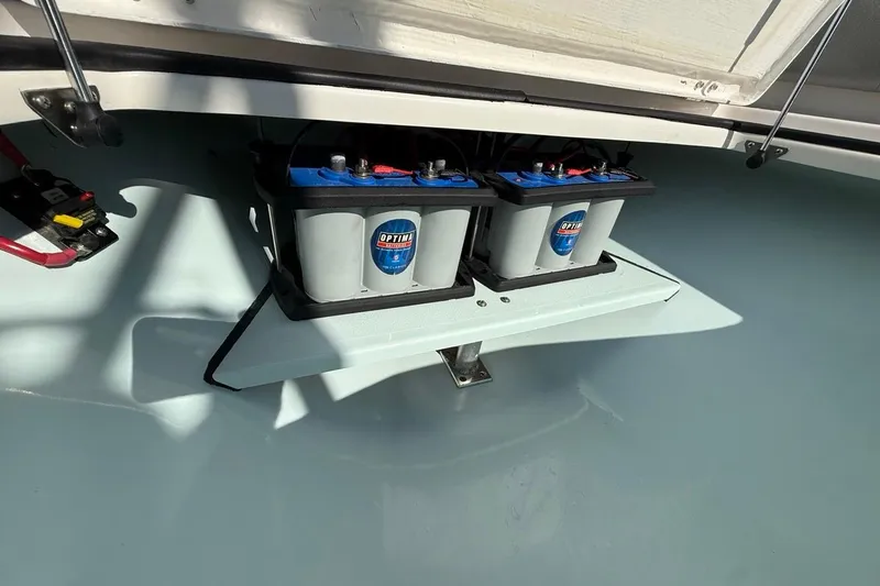 Slide: The Image of 2024 Xplor X24 boat battery compartment with dual Optima batteries. - 38