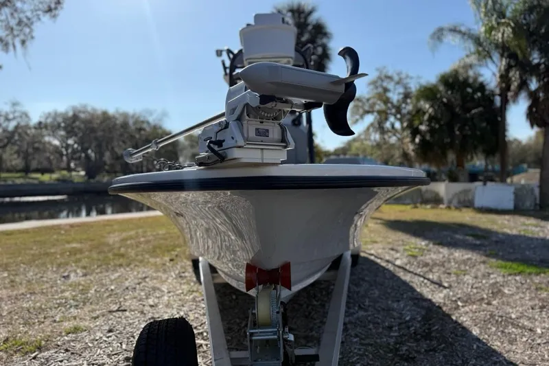 Slide: The Image of 2024 Xplor X24 boat on trailer, parked outdoors with trees in background. - 4