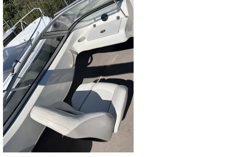 Slide: The Image of 2015 Stingray 191 RX boat interior with white seating and dashboard. - 5