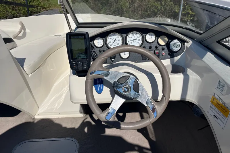 Slide: The Image of 2015 Stingray 191 RX boat dashboard with steering wheel and gauges. - 6
