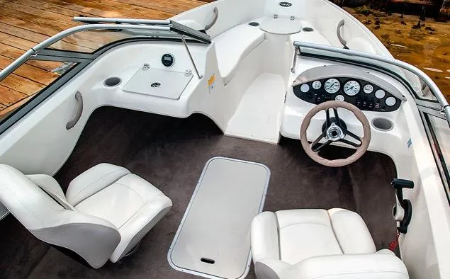 Slide: The Image of Manufacturer Provided Image: 2015 Stingray 191 RX boat interior with white seats and dashboard. - 9