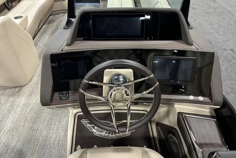 Slide: The Image of 2026 Bennington 25 RXFBA boat dashboard with modern steering and digital displays. - 4