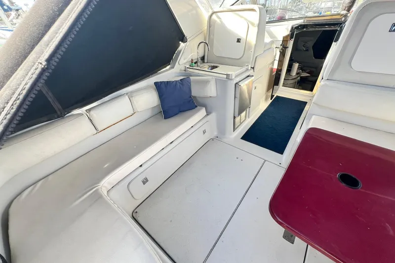 Slide: The Image of 1987 Chris-Craft 412 Amerosport interior with seating, sink, and table. - 11