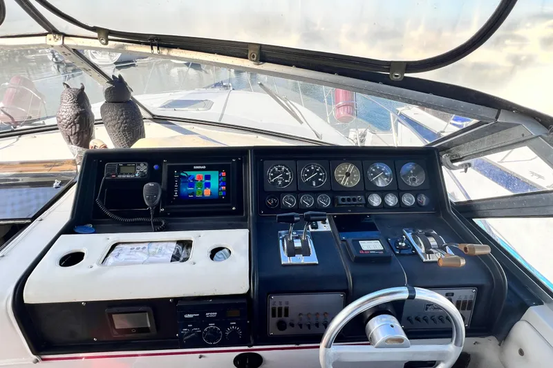 Slide: The Image of 1987 Chris-Craft 412 Amerosport helm with gauges, controls, and navigation equipment. - 13