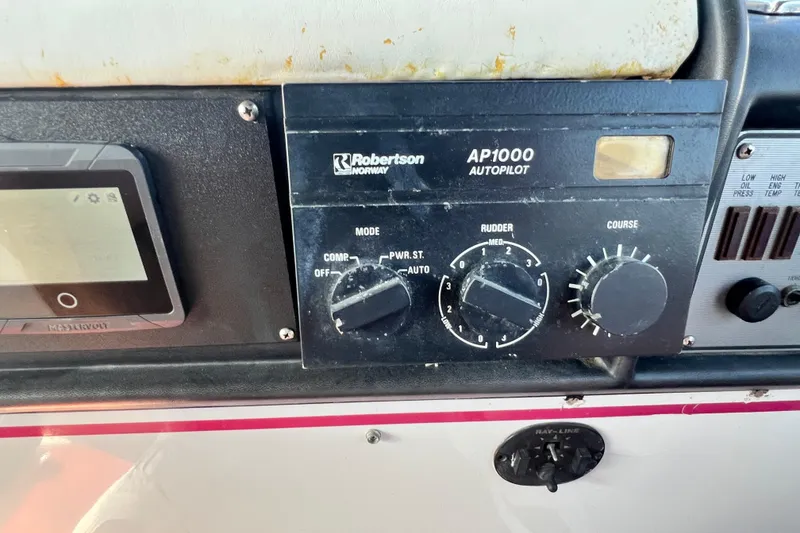 Slide: The Image of Autopilot controls on a 1987 Chris-Craft 412 Amerosport boat dashboard. - 16