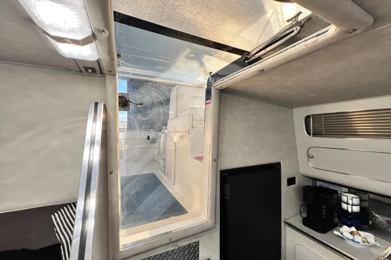 Slide: The Image of Interior of 1987 Chris-Craft 412 Amerosport boat, featuring a hatch and kitchenette area. - 20