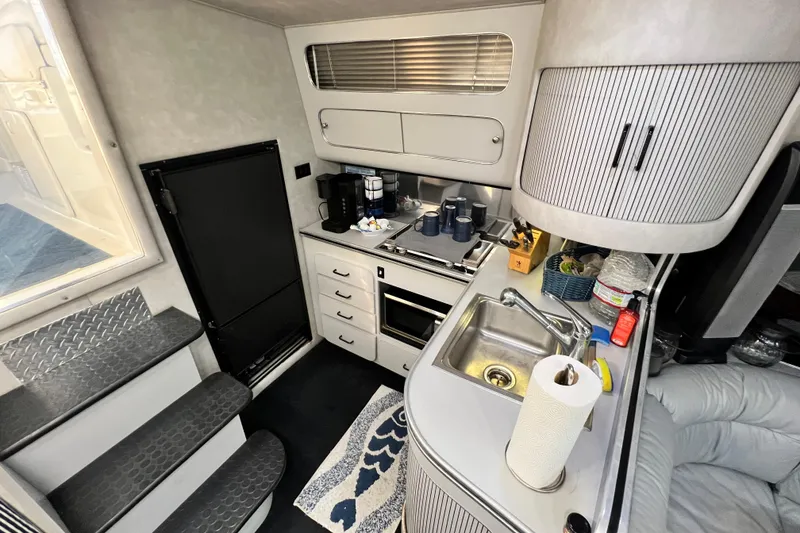 Slide: The Image of 1987 Chris-Craft 412 Amerosport yacht interior with kitchenette, sink, and appliances. - 22