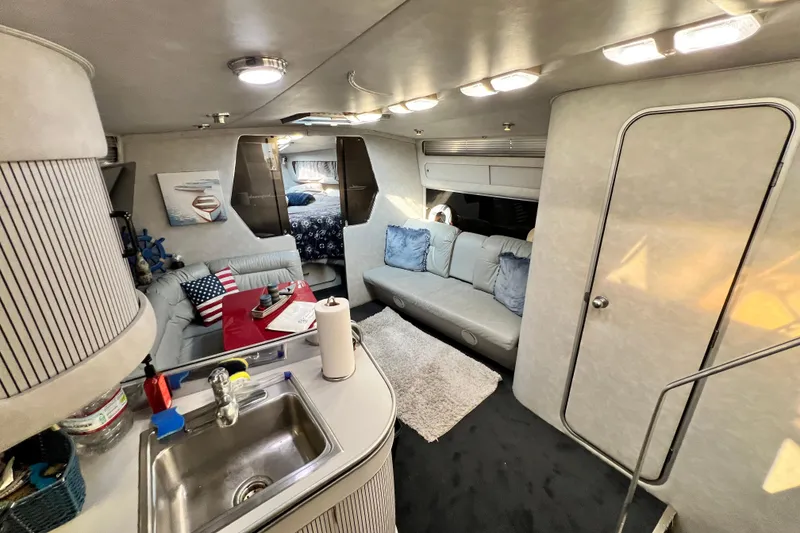 Slide: The Image of Interior of 1987 Chris-Craft 412 Amerosport yacht with cozy seating and kitchenette. - 24