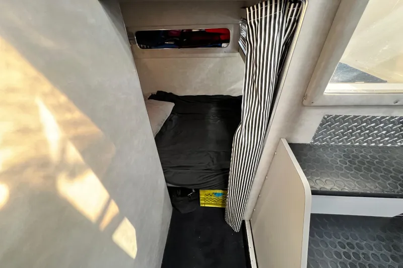 Slide: The Image of 1987 Chris-Craft 412 Amerosport cabin interior with bed and striped curtain. - 25