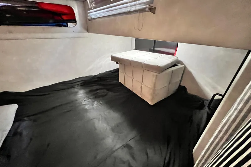 Slide: The Image of Interior cabin of 1987 Chris-Craft 412 Amerosport with black bedding and white ottoman. - 27