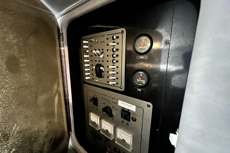 Slide: The Image of Electrical panel of 1987 Chris-Craft 412 Amerosport boat, featuring gauges and switches. - 28