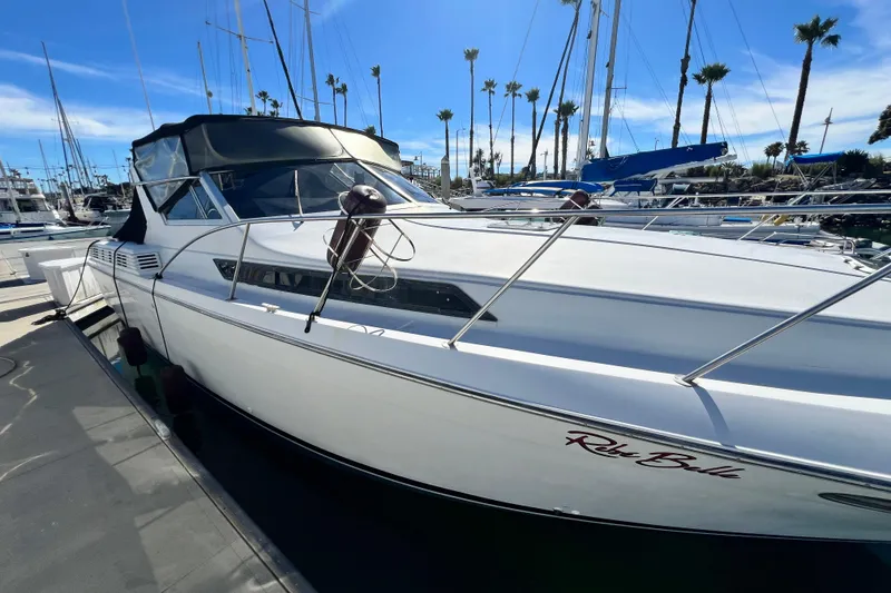 Slide: The Image of 1987 Chris-Craft 412 Amerosport yacht docked in marina under clear blue sky. - 3