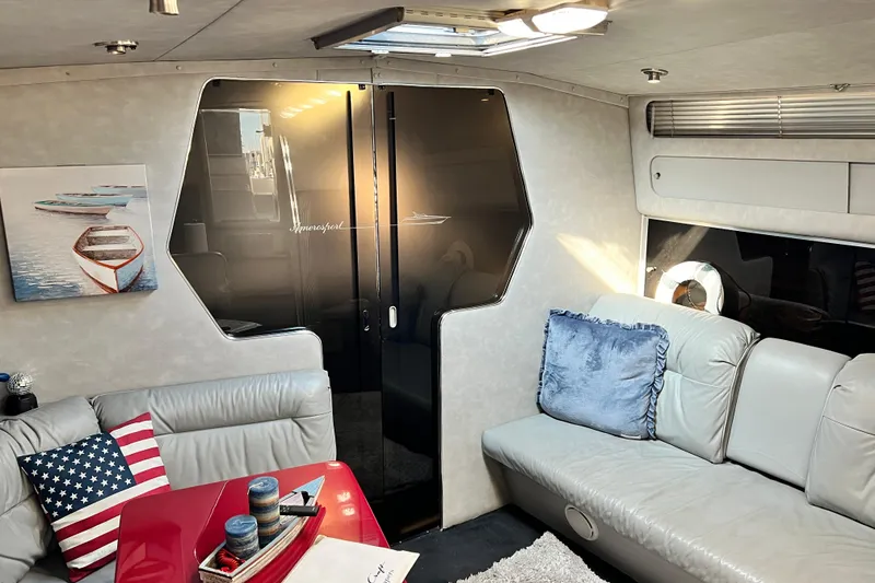 Slide: The Image of Interior of 1987 Chris-Craft 412 Amerosport yacht with modern decor and comfortable seating. - 30