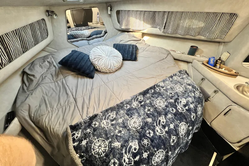 Slide: The Image of Cozy cabin interior of 1987 Chris-Craft 412 Amerosport with nautical-themed bedding. - 32