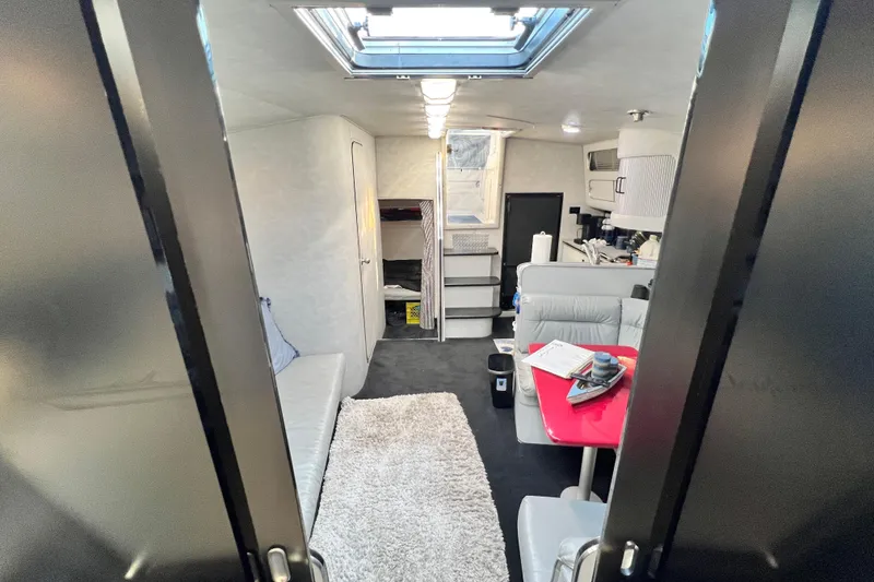 Slide: The Image of Interior of 1987 Chris-Craft 412 Amerosport yacht, featuring modern seating and skylight. - 35