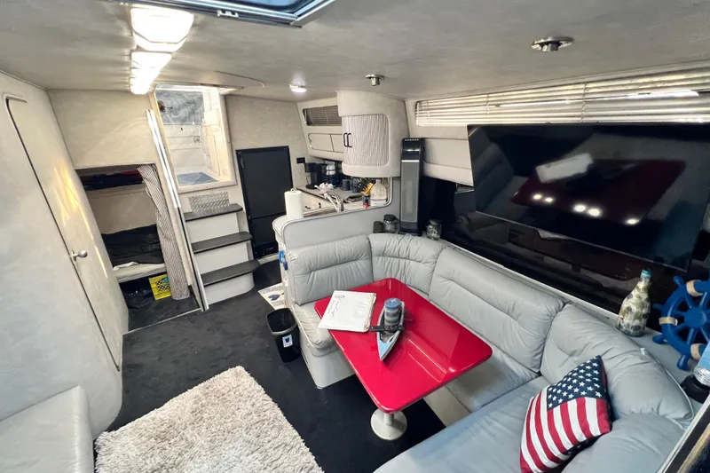 Slide: The Image of Interior of 1987 Chris-Craft 412 Amerosport yacht with modern seating and red table. - 37