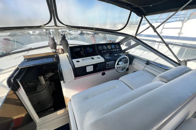 Slide: The Image of 1987 Chris-Craft 412 Amerosport boat interior with helm, dashboard, and seating area. - 8