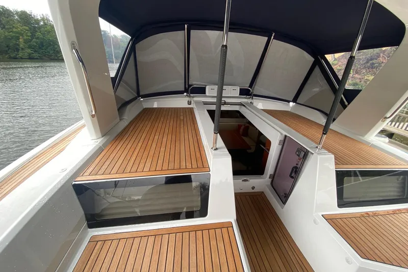 Slide: The Image of 2019 Beneteau Oceanis 51.1 yacht deck with teak flooring and canopy. - 11