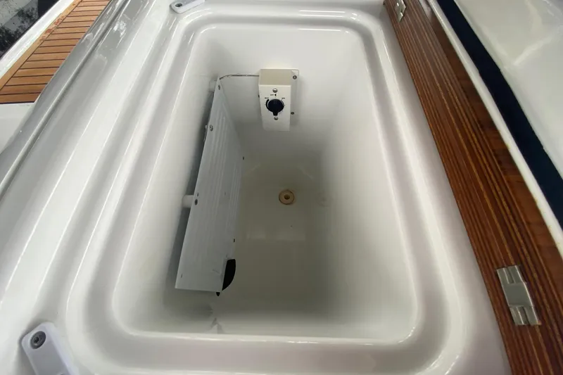 Slide: The Image of Storage compartment on 2019 Beneteau Oceanis 51.1 yacht, featuring wooden trim and white interior. - 13