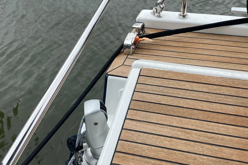 Slide: The Image of Teak deck of 2019 Beneteau Oceanis 51.1 yacht with mooring line and railing. - 17